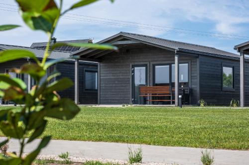 a house with a bench in the front yard at Silva in Rewal