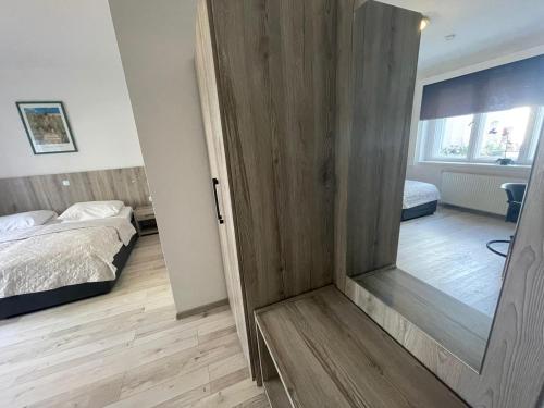 a room with a door leading to a bedroom at Pension Der Kretaner in Berlin