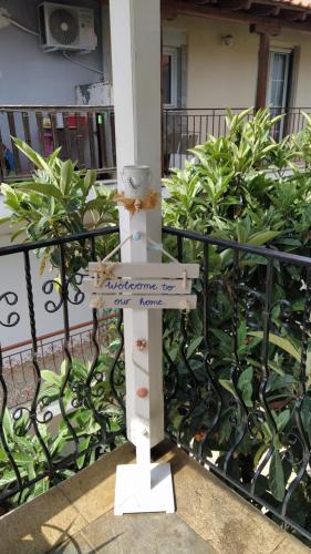 a cross with a sign on a fence at VILLA KALIBA SUMMER HOUSE in Kalivia Poligirou