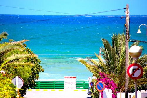 a view of the ocean from a street at Los Naranjos in Guardamar del Segura