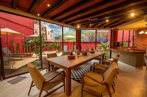 a dining room with a table and chairs at La Casona Colorada San Felipe del Agua in Oaxaca City