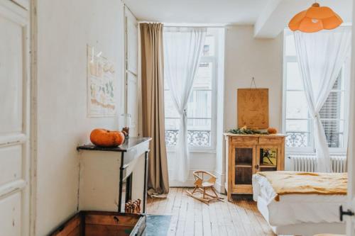 a bedroom with a bed and a large window at Maison Séraphine - Guest house - Bed and Breakfast in Laon