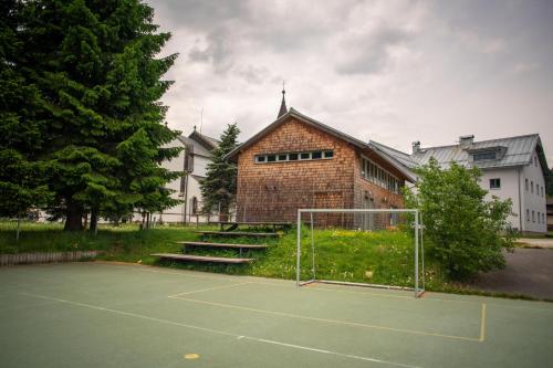 a tennis court in front of a building at Stará Celnice Kvilda in Kvilda