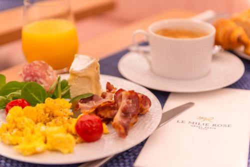 a plate of breakfast food and a cup of coffee at Hôtel Le Milie Rose in Paris