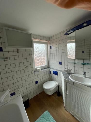 een badkamer met een toilet en een wastafel bij Ferienwohnung Bartenwetzerbrücke 2 in Melsungen