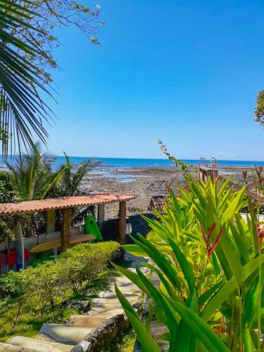 a bench on the beach with the ocean in the background at Hotel Santa Catalina Panamá in Santa Catalina