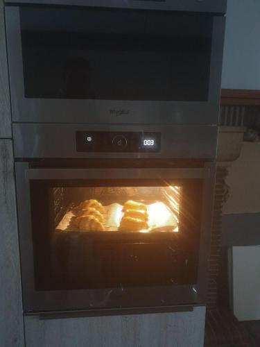 a oven with some food cooking in it at Chambres de Villée in Saint-Georges-de-Gréhaigne