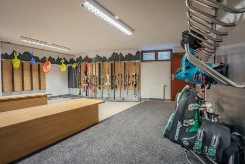 a room with skis and snowboards on the wall at Garni Hotel Miklič in Kranjska Gora