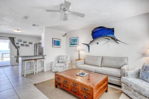 a living room with a couch and a table at Beachfront Ocean Duplex in Layton