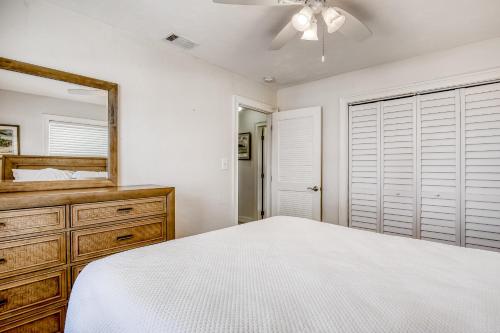 a bedroom with a bed and a mirror and a dresser at Beachfront Ocean Duplex in Layton