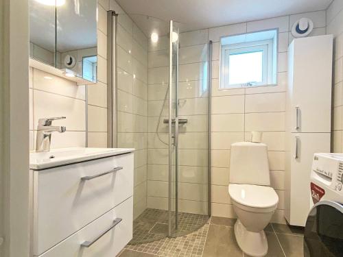 a bathroom with a toilet and a sink and a shower at 4 person holiday home in FÄRJESTADEN in Färjestaden