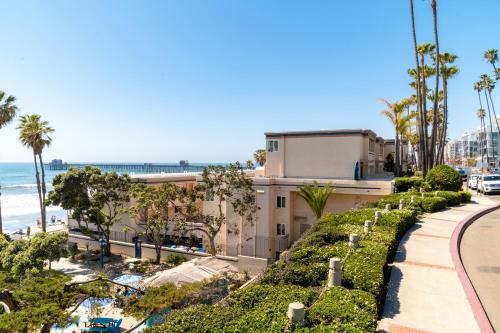 a view of the beach from the balcony of a building at Southern California Beach Club in Oceanside