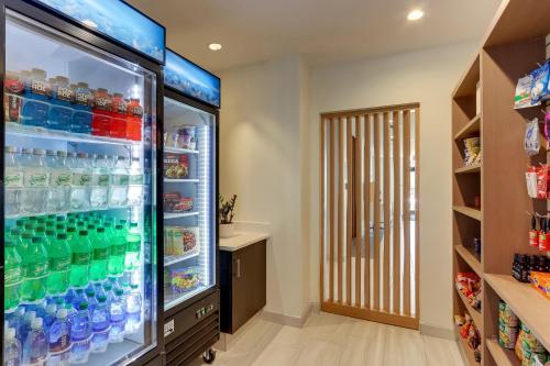 a large refrigerator filled with lots of drinks at Holiday Inn Express - Wilmington - Porters Neck by IHG in Wilmington