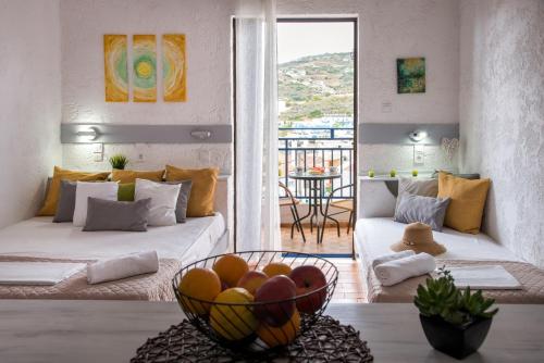 a living room with a bowl of fruit on a table at Amazona in Agia Pelagia