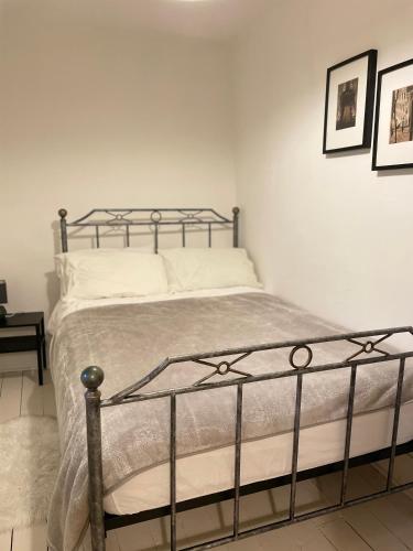 a bedroom with a bed with a metal frame at Mole Cottage in Stocksfield