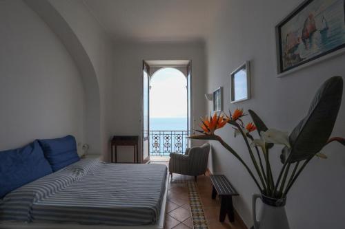 a living room with a bed and a window at Casa di charme panoramica a Capri sulla spiaggia. in Capri