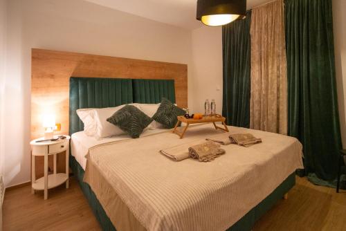 a bedroom with a large bed with green curtains at Guest house DIA - Details make a diference in Biograd na Moru