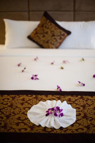 a hotel room with a flower on a bed at Muong Thanh Holiday Quang Binh Hotel in Dong Hoi