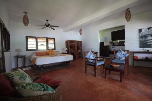 a large living room with a bed and a couch at Sol Caribe in Punta Allen