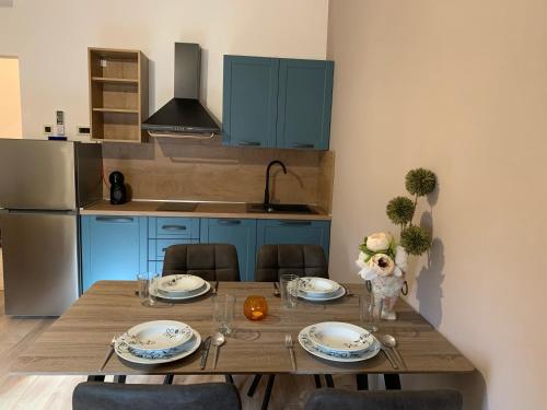 a kitchen with a wooden table with blue cabinets at Parentium town center in Poreč