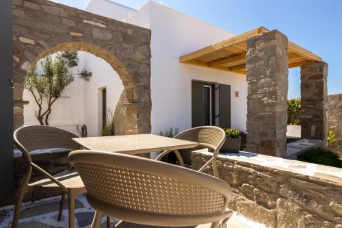 an outdoor patio with a table and chairs at Sea & Sun Paros in Naousa