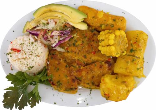 a plate of food with chicken and corn and vegetables at Hotel Barcelona Chinauta in Chinauta