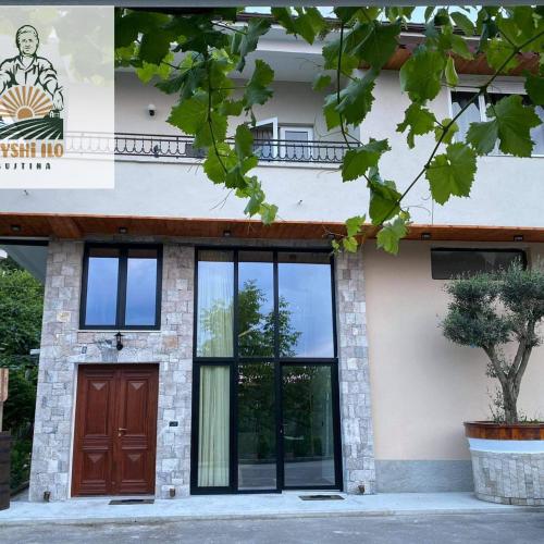 a facade of a building with a door at Bujtina Gjyshi Ilo in Pogradec