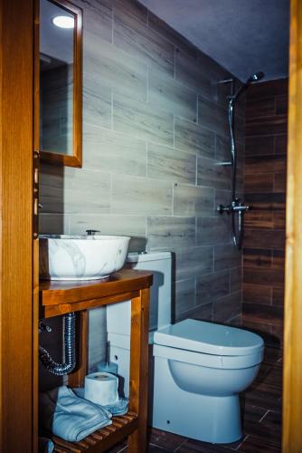 a bathroom with a toilet and a sink at Medieval Rooms in Gjirokastër