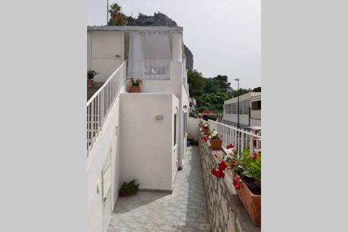 a white building with flowers on the side of it at Casa Martulè (vista mare) - Marina Piccola, Capri in Capri