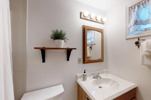 a white bathroom with a sink and a mirror at Brookhaven Condos in Ludlow