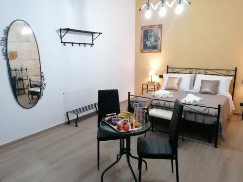 a bedroom with a bed and a table with a tray of food at B&B 36 Passi dal mare 2.0 in Trapani