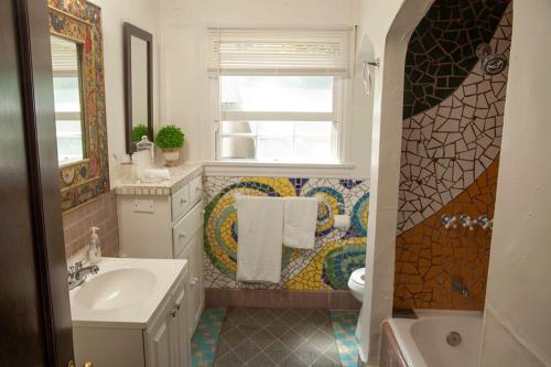 a bathroom with a sink toilet and a window at Hidden Weekend Getaway in NoHo in Los Angeles