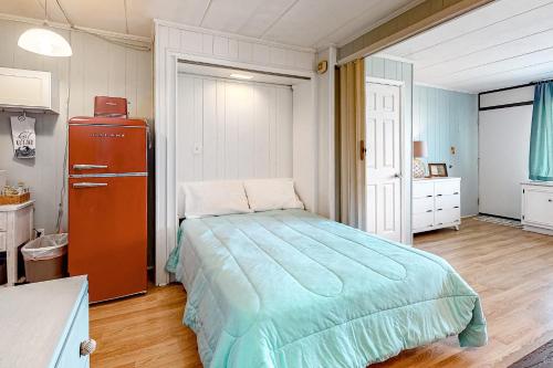a bedroom with a bed and a dresser in it at Three Cheers in Ocean City