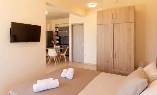 a bedroom with a bed with two towels on it at Cretan fleur apartments in Elafonisi