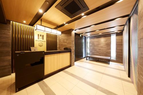 a lobby with a reception desk in a building at MONday Apart Premium UENO OKACHIMACHI in Tokyo