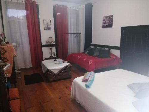 a bedroom with two beds and a table in it at AL- Almada 4 in Porto