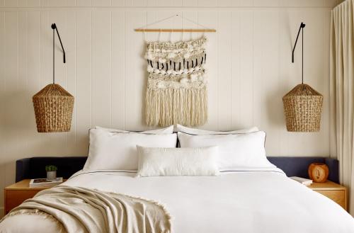 a bedroom with a large white bed with white pillows at Gurney's Montauk Resort & Seawater Spa in Montauk