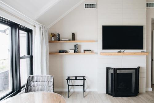 a living room with a flat screen tv on a wall at Gurney's Montauk Resort & Seawater Spa in Montauk
