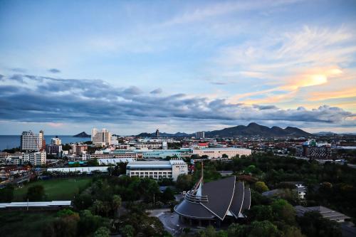 a view of a city at sunset with a building at Hua Hin Grand Hotel and Plaza - SHA Extra Plus in Hua Hin