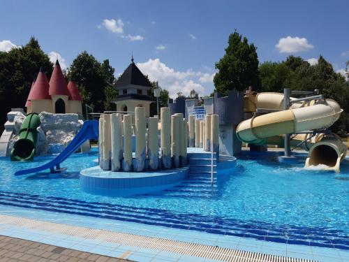 a pool at a water park with a water slide at Tukán Apartman Hajdúszoboszló in Hajdúszoboszló