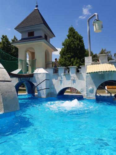 a water slide in a water park with a bridge at Tukán Apartman Hajdúszoboszló in Hajdúszoboszló