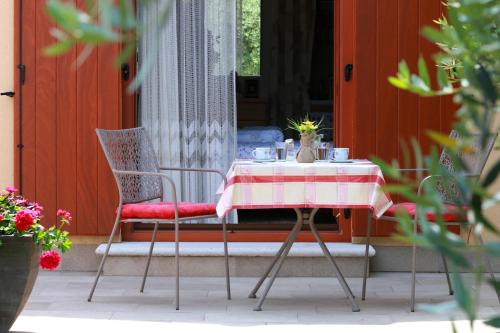 a table with a red and white table cloth on it at Studio Apartment Volta in Crveni Vrh