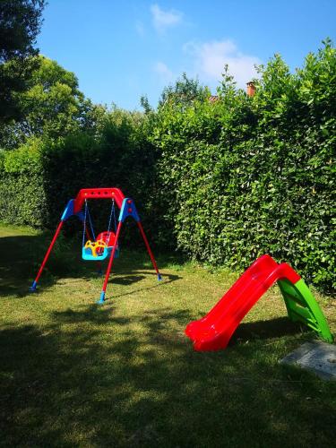 two childrens play equipment in the grass at Villa Franco in Orentano