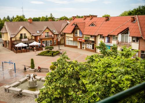 a view of a town with a fountain and buildings at Hotel KAVKA & Restauracja in Czersk Pomorski