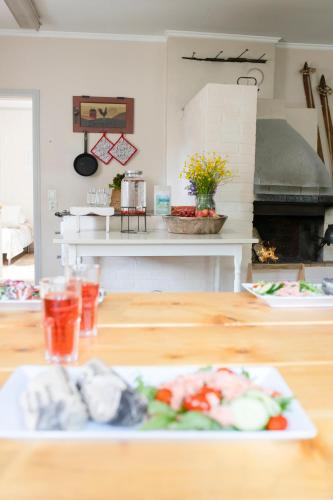 a table with a plate of food on top of it at Karkausmäen Kammari in Kinnula