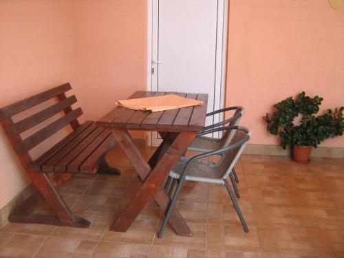 a wooden table and chair with a napkin on it at Apartments Milosevic in Bar