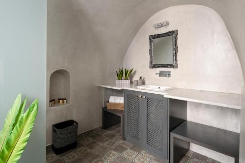 a bathroom with a sink and a mirror at Betty's Home Santorini in Karterados