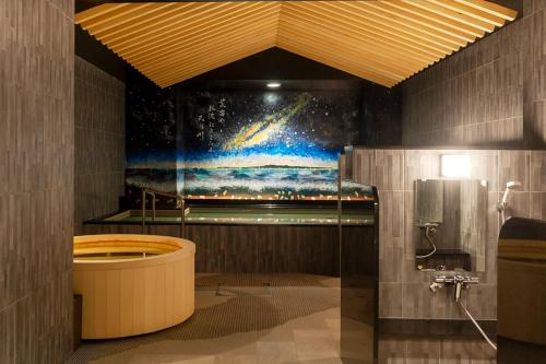 a bathroom with a painting of a universe at HOTEL GLOBAL VIEW Niigata in Niigata