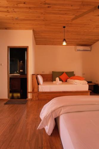 a bedroom with two beds and a couch in it at Akasha Beach Club in Bulukumba