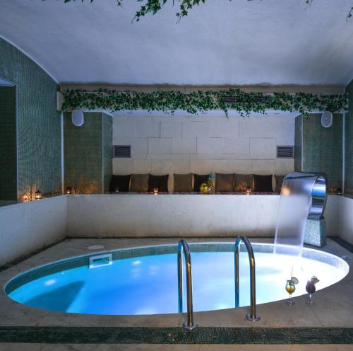 a hot tub in a room with a fireplace at Heritage Hotel Krone in Sarajevo